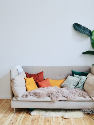 orange throw pillows on white couch